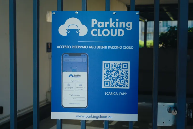Cartello Parking Cloud su un cancello: accesso riservato agli utenti Parking Cloud, con il QR code per scaricare l'app